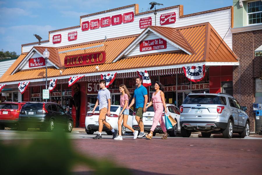 Family walking in front of general store in downtown Branson.