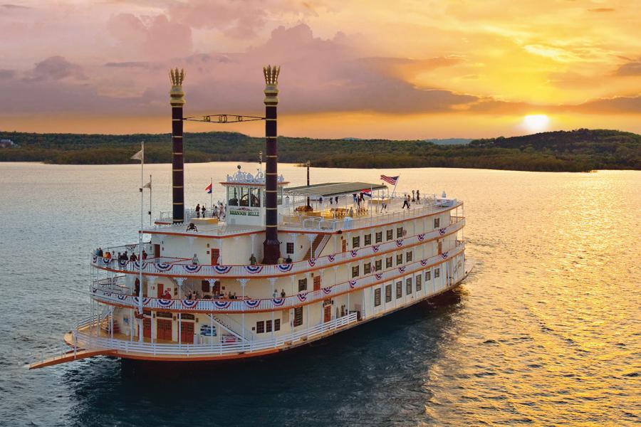 Sunset behind Showboat Branson Belle on the lake.