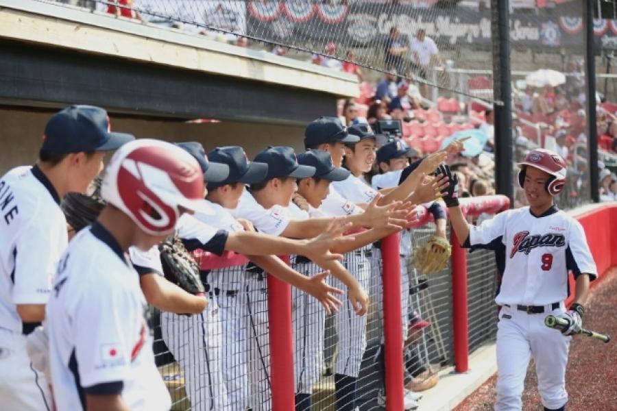 baseball team high fives on the ballparks of america field in Branson MO