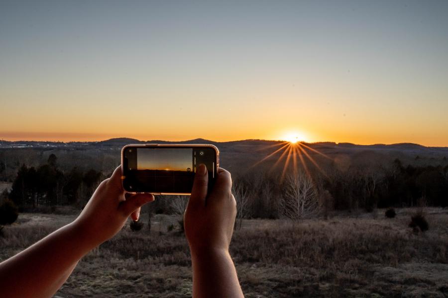 taking a picture of a sunset in Branson