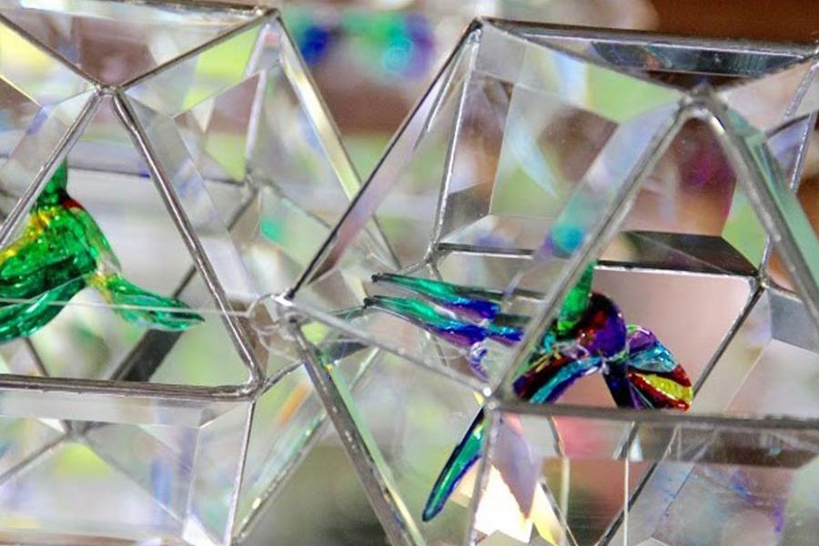 Glass prisms that hold small glass animal figurines at a craft mall in Branson.