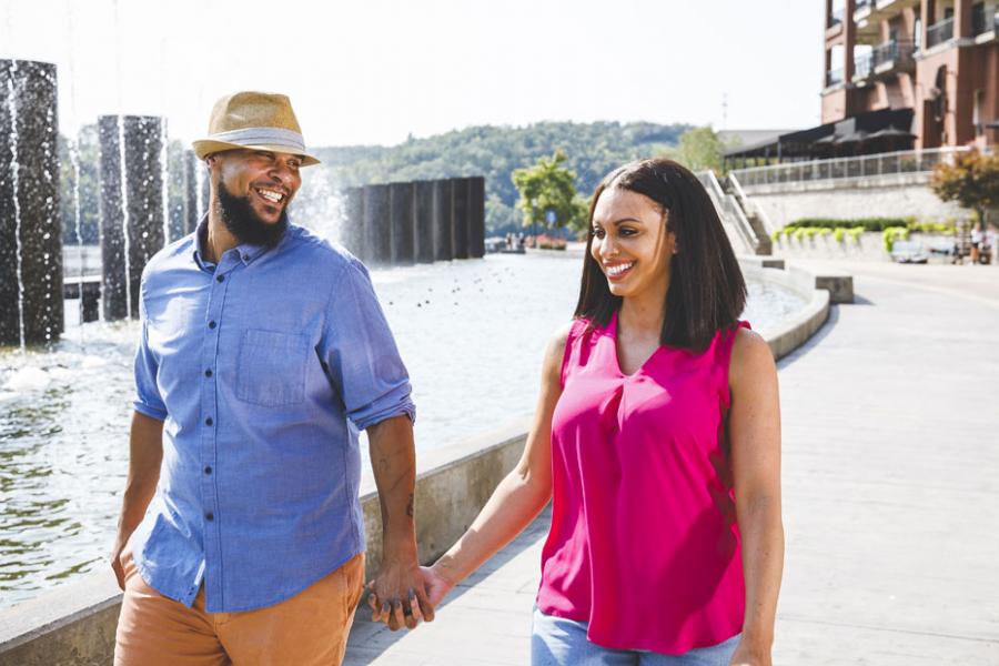 Middle-aged couple holding hands at a shopping center in Branson. 