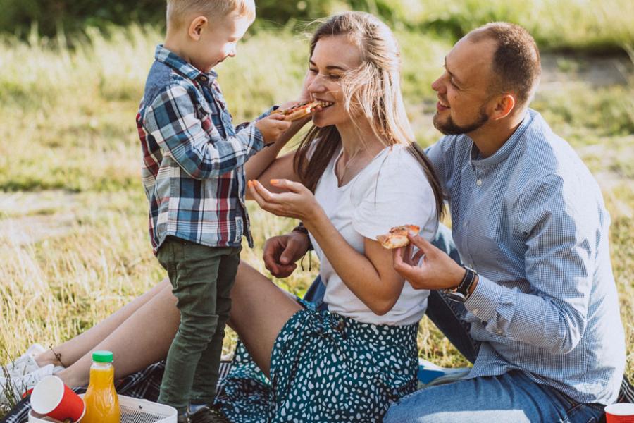 Father, mother and son having a picnic at the park in Branson. 