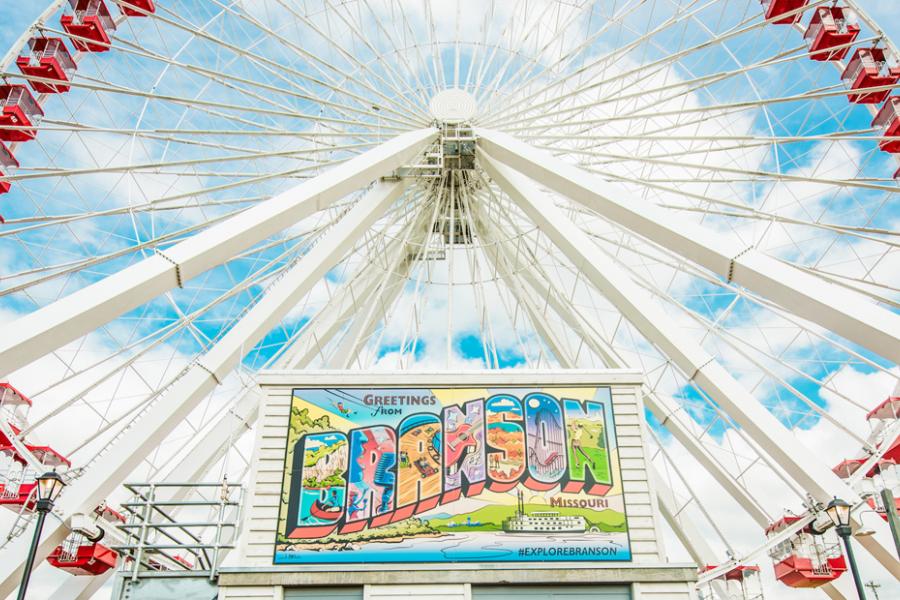 Mini Branson mural and Branson Ferris Wheel under a beautiful blue sky.
