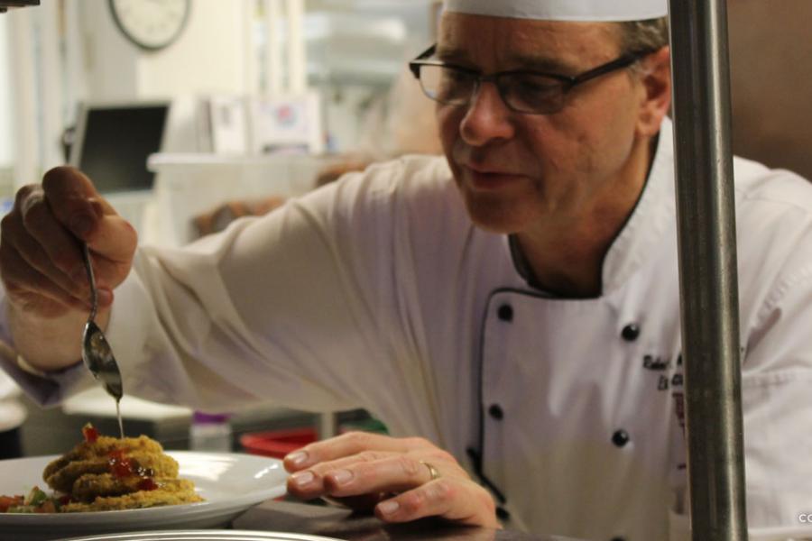 Executive chef decorating a plate of food to be served at the Keeter Center restaurant in Branson. 