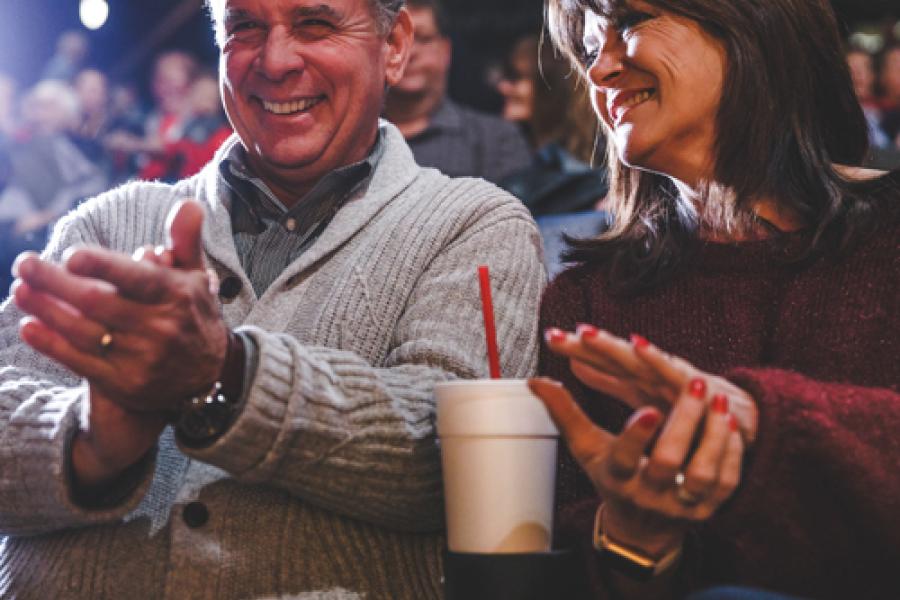 Middle-aged couple sitting in a theatre about to watch a show in Branson.