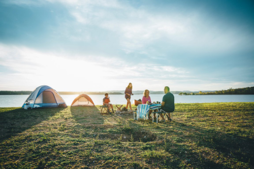 family camping on lakeshore