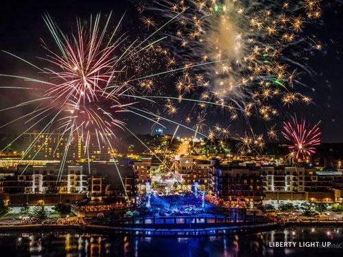 Fireworks show over large outdoor shopping complex on the lake in Downtown Branson. 