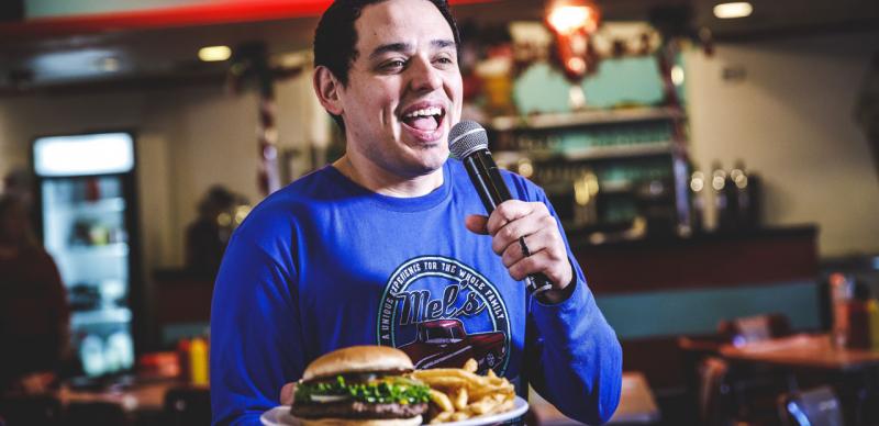 Singing server at a small diner in Branson singing while serving a burger and fries.