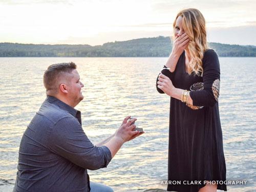 Man on one knee proposing to girlfriend.