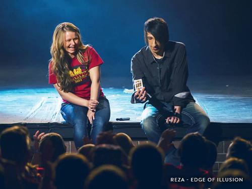 Illusionist doing a card trick in front of a crowd in Branson.