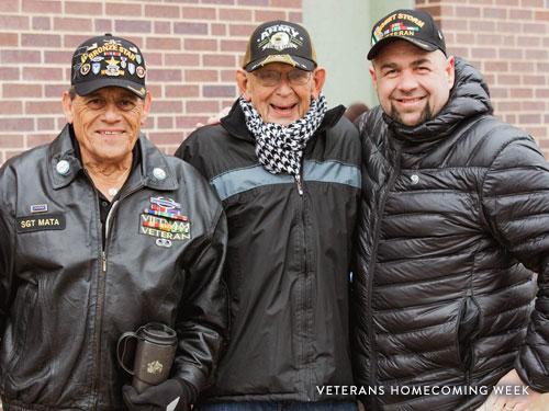 Three Veterans posing for picture at annual Veterans Homecoming Parade in Branson.
