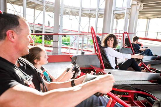 a family enjoying riding go karts on a nice day